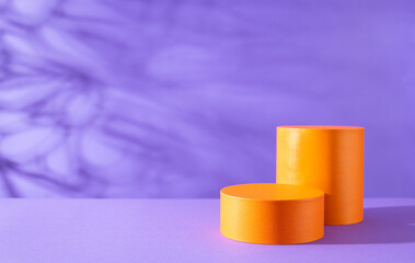 Halloween holiday concept. Orange Podiums or pedestals for products display on purple background.