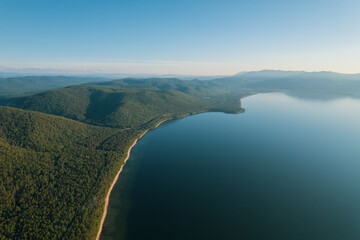 Obraz premium Summertime imagery of Lake Baikal is a rift lake located in southern Siberia, Russia Baikal lake summer landscape view from a cliff near Grandma's Bay. Drone's Eye View.