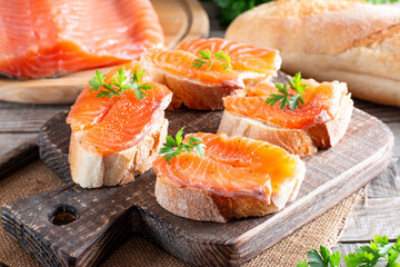 Open sandwich, toast with salmon, butter on table. Morning healthy breakfast with fish