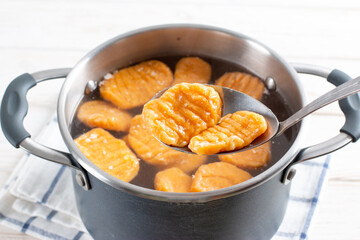 Gnocchi being prepared. Boiling. Dough dumplings with pumpkin