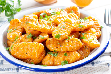 Gnocchi with a pumpkin on the plate. Italian dumplings with butter.