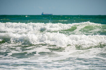 Waves of the Black Sea on a clear day. Boat in the background.