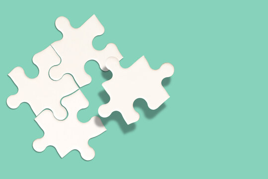 White jigsaw puzzle on green background, Find the right joined team and fit correctly concept