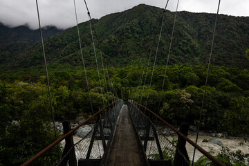 beautiful suspension bridge in the new zealand mountains