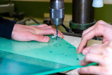 Closeup shot of drilling a glass surfce