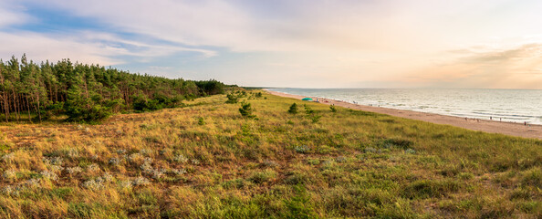 Beautiful Baltic Sea coastline in Darłówko, Poland. Panoramic view at pine forest, sand dunes...