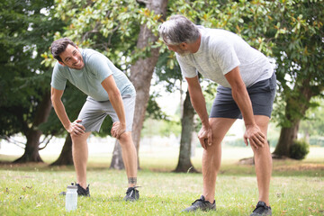 men bending over as they recover