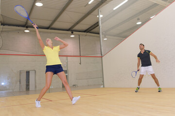 Fototapeta na wymiar couple playing squash in indoor court