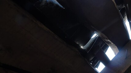 Rays of bright sunlight shine through narrow access windows in industrial building at construction site on sunny day close bottom view - Powered by Adobe