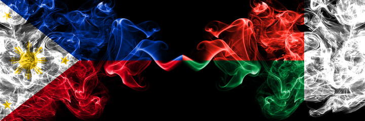 Philippines, Filipino vs Madagascar smoke flags side by side.