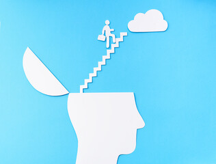 Uplifting and business prosper Concept, Paper Cut Open head with stairs up to the cloud
