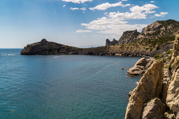 Fototapeta premium The Republic of Crimea. July 15, 2021. View of Cape Kapchik, a silhouette resembling a dolphin in the Blue Bay near the village of Novy Svet.