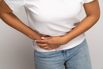 Cropped image of painful woman touching right side suffer from acute abdominal pain in stomach, appendix or kidney. Unhealthy female feel inflammation cramp touch ribs. Medicine and healthcare concept