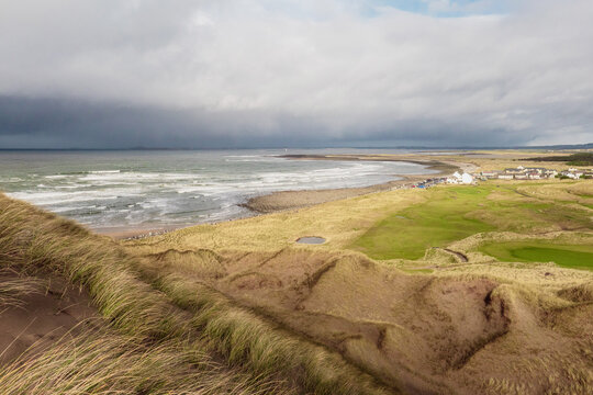 View on Strandhill beach and town in county Sligo, Ireland. Popular holiday destination for nature scenery and surfing sport. Dramatic storm clouds over the ocean