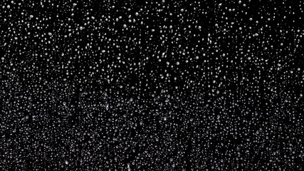 Raindrops on the window covering the entire surface and rolling down one by one on the black background, isolated on alpha channel with luminance matte. © railwayfx