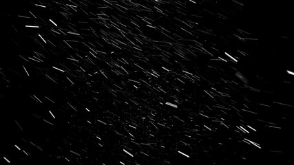 Heavy snow falling from left to right on the black background. Severe blizzard with strong wind and a lot of snow falling almost horizontally.