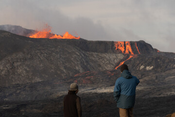 Beautiful view of the Active Grindavik Volcano with red Lava and tourists contemplating ir in...