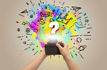 Close-up of a hand holding digital camera with abstract drawing concept