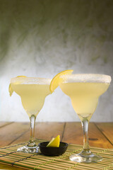 delicious and refreshing alcoholic drink with citrus fruits, margarita, cozumel on a table in a glass cup on the dark background