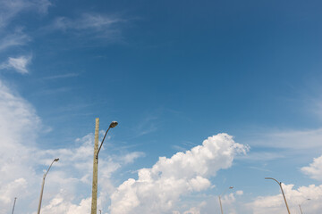 lamp posts and blue sky with some clouds