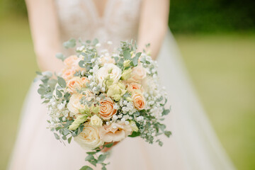 Bride holds a boho bridal bouquet with eucalyptus