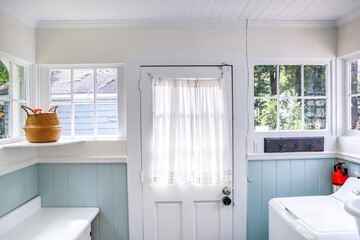 A vintage laundry room filled with windows and natural light