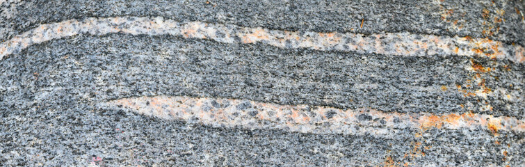 Rounded, weathered, river rock, closeups in nature as textured background
