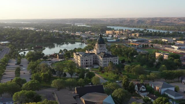 South Dakota state Capitol building in Pierre, SD. Wide aerial drone footage of state government buildings.