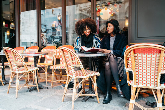 two Black women sitting in a cafe