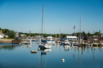 Fototapeta na wymiar sailboats anchored in a bay of Maine coast fishing port