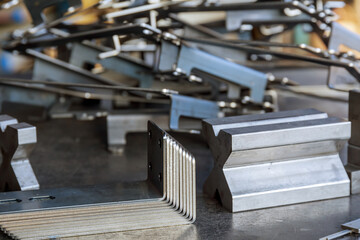 Sheet metal product after processing on a bending machine. Production of fastening from metal for construction.