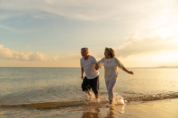 Family On Summer Beach Vacation, healthy older couple running on sea beach, Concept for .caring for...