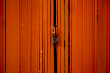 closed orange metal folding gate.