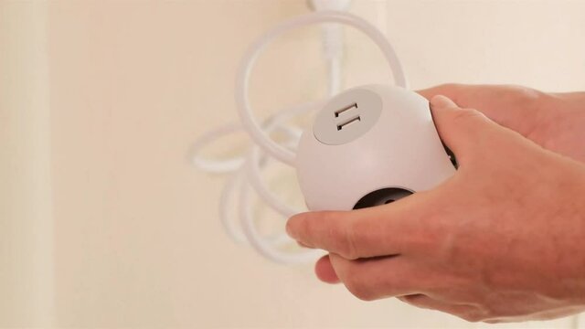electric extender .square socket with USB connectors .Power socket.electric square extension cord in male hands. Rosette .Electrical outlet. High quality 4k footage