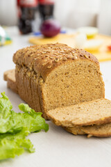 detail of a sliced wholemeal bread mold next to a lettuce, food ingredients in study, food