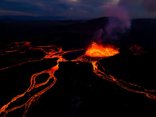 Beautiful aerial view at night of the Active Volcano with red Lava in Iceland