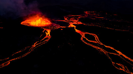 Beautiful aerial view at night of the Active Volcano with red Lava in Iceland