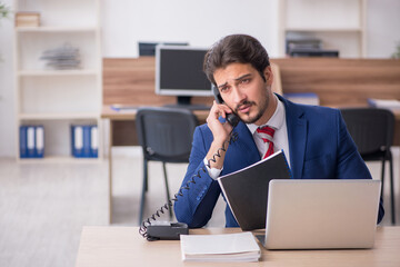 Young male employee working in the office