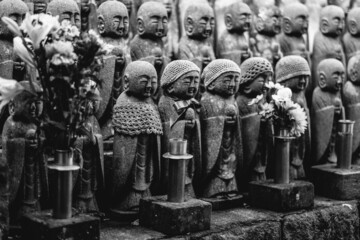 Lots of little 'Jizo' stone statues (representation of guardians of little dead kids) and flowers...