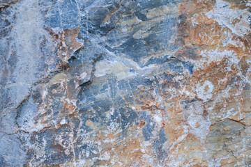 Texture of stone surface with gray, brown and white colors. Top view.