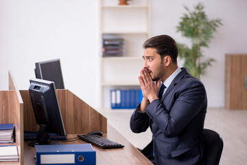 Young male employee working in the office