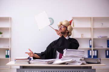 Funny young male employee magician and too much work in the office