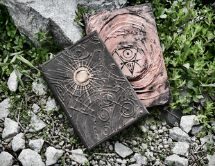Grunge still life with two decorated witch books of magic spells.