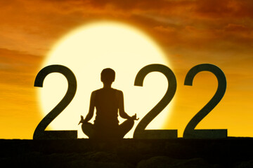 Woman practice yoga while sits with 2022 numbers