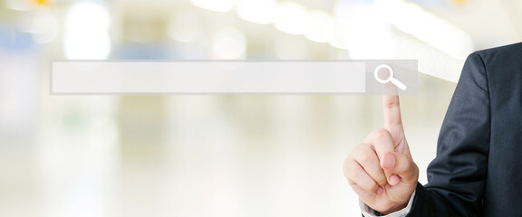 Businessman hand touching blank search bar over blur background, business and technology concept, search engine optimization, web banner