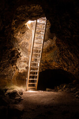 Underground lava tube caves accessed by sturdy ladders for explorers - 453709609