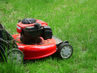  close up on lawn mower on green lawn