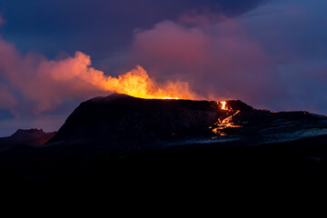 Fototapeta premium Beautiful aerial cinematic footage of the bowling lava exploding from the Active Volcano in Iceland