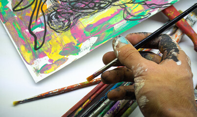 artist painting with brushes. space for text