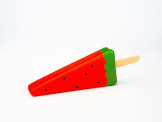 Artificial watermelon slice popsicle, isolated on white background. Summer fruit ice cream stick.